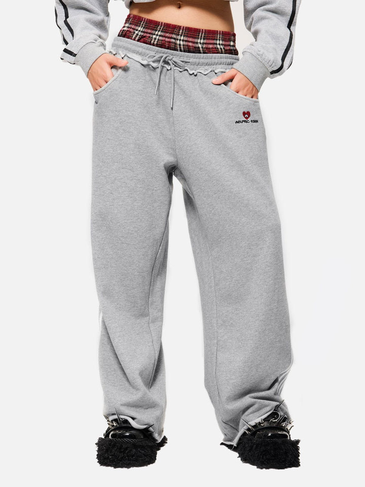 Jazzlyn - Pantalon de jogging grise chic avec une luxueuse ceinture double pour confort et style.