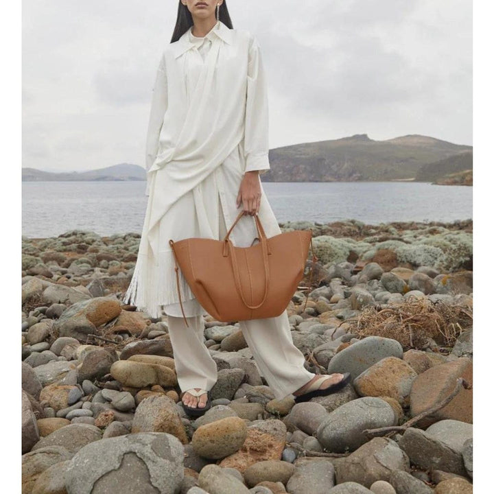 Spacious women's leather tote bag for laptop, ideal for autumn and work