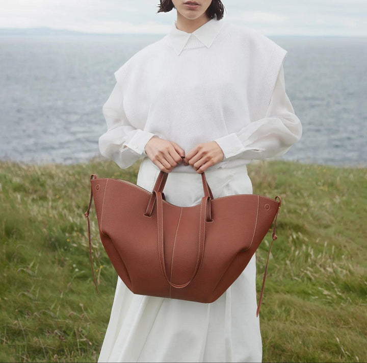 Spacious women's leather tote bag for laptop, ideal for autumn and work