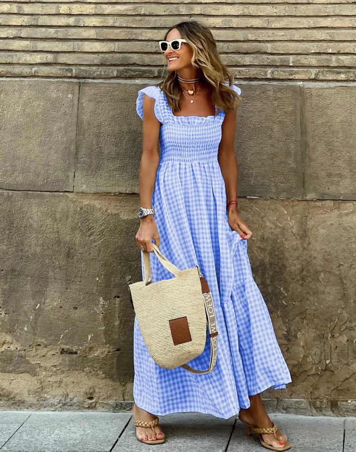 https://cdn.shopify.com/s/files/1/0998/9200/3147/files/Women_s_Smocked_Gingham_Maxi_Dress_with_Ruffle_Sleeves_4.png?v=1766785420