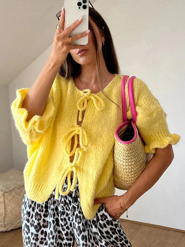 Women's wool-knit cardigan with bow details, an open and elegant design for autumn