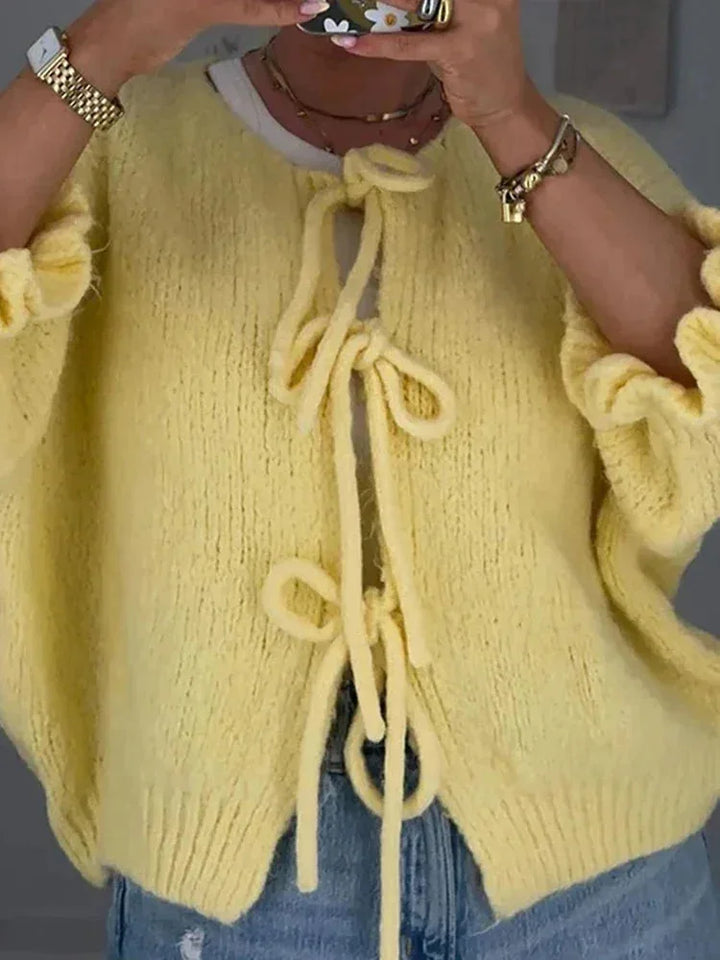 Women's wool-knit cardigan with bow details, an open and elegant design for autumn