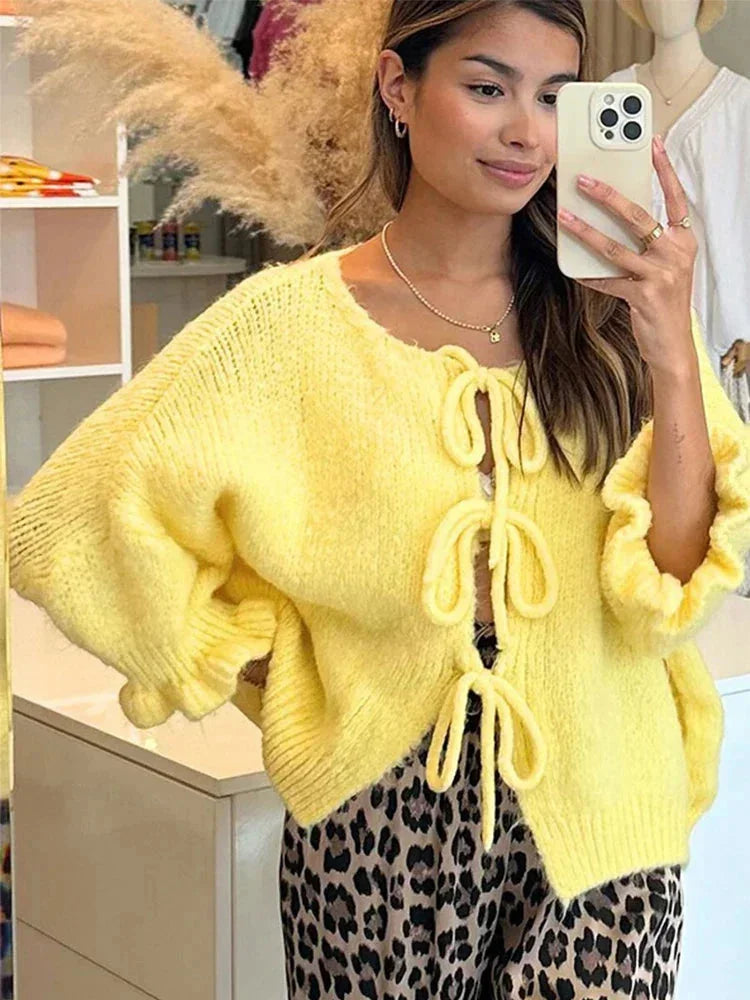 Women's wool-knit cardigan with bow details, an open and elegant design for autumn