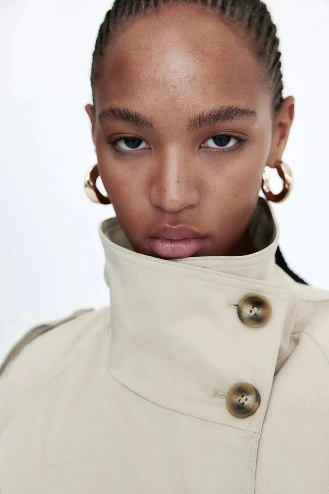 Elegant women’s trench coat with a stand-up collar and tie belt for autumn