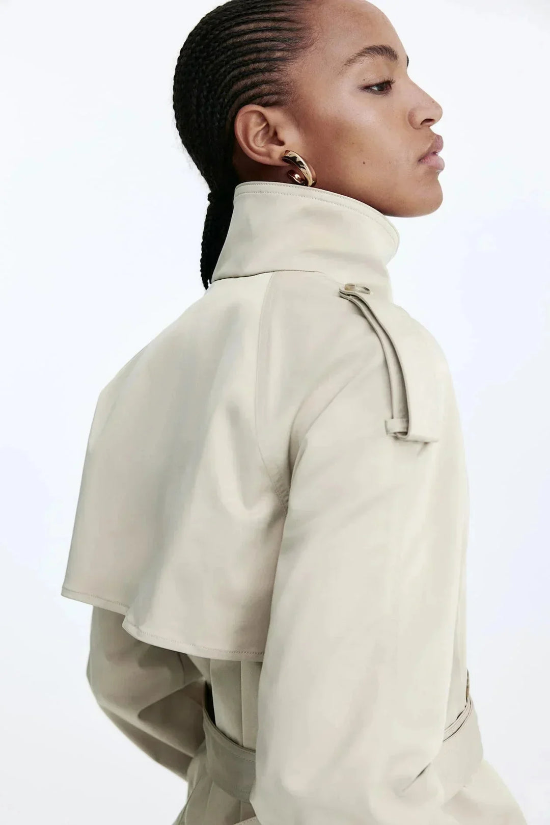 Elegant women’s trench coat with a stand-up collar and tie belt for autumn